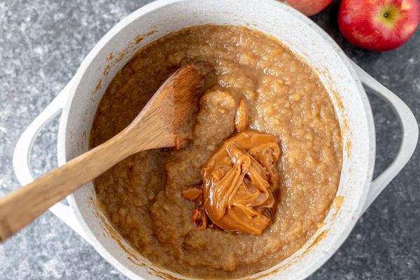 stirring caramel into the apple butter