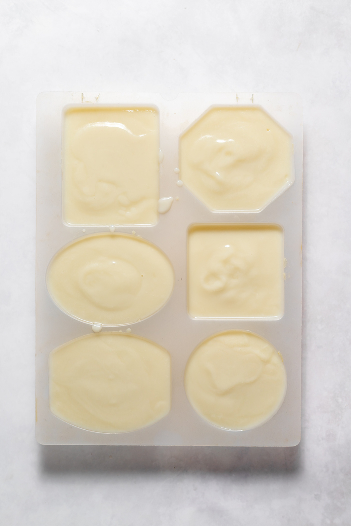 Photo taken from above shows goat milk soap in molds, ready to cure