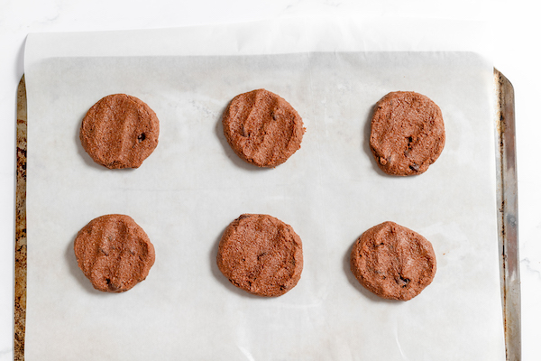 Image shows the hot chocolate cookies laid out on a baking sheet to be baked. 