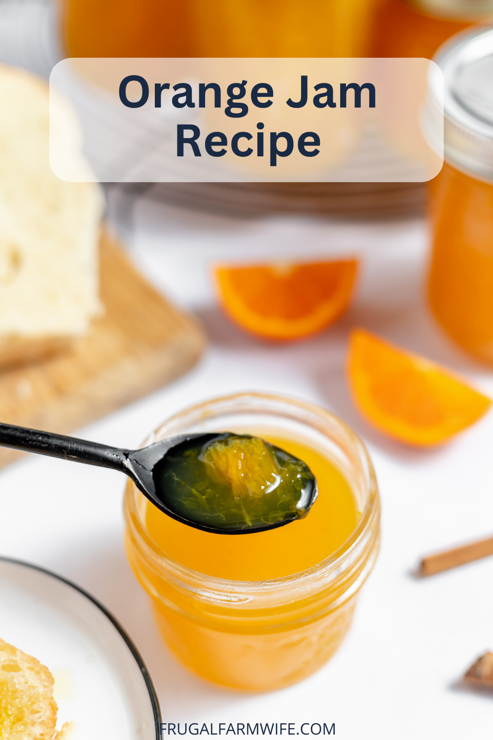 Image shows a small jar of orange jam with a spoon hovering over it. The spoon holds a small amount of jam. Around the jar are slices of oranges. Text above reads "Orange Jam Recipe"