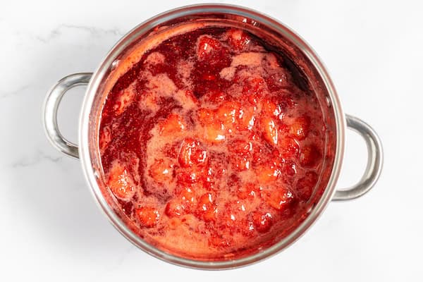 a kettle of boiling strawberry jam