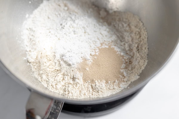 Image, taken from above, shows flour, salt, and yeast in a mixer