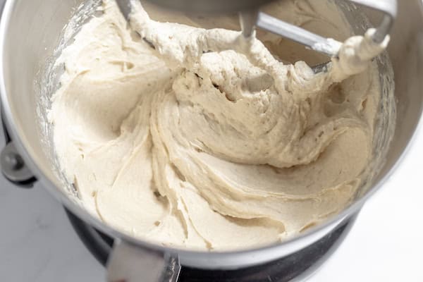 Image, taken from above shows a stand mixer mixing gluten free focaccia dough