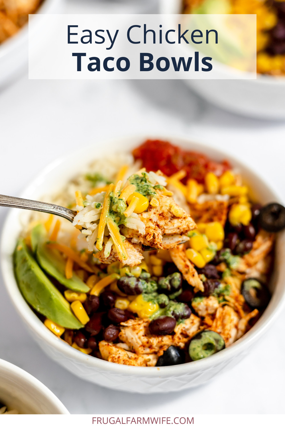 Image shows a close up of a large bowl of chicken taco bowls topped with corn, cheese, avocado and beans. Text above reads "Easy Chicken Taco Bowls."