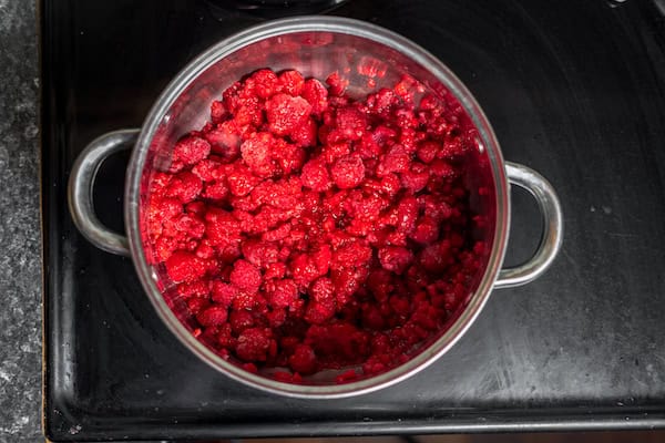 red raspberries in a pot to make jam