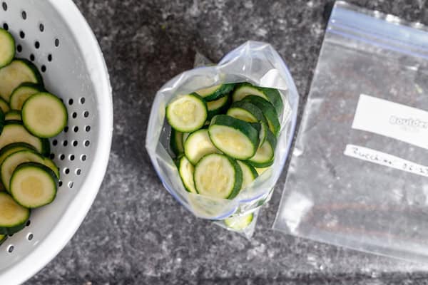 packing blanched zucchini into freezer bags