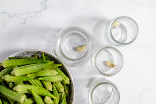placing garlic in the bottom of canning jar