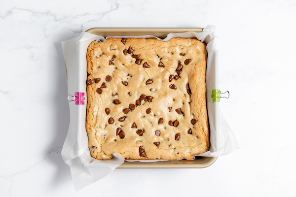 Image, taken from above, shows baked gluten free blondies in a square pan