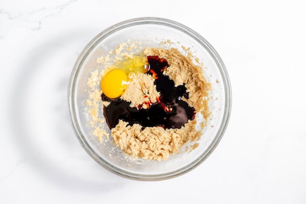 Image, taken from above, shows the butter, sugar, blackstrap, and egg in bowl ready to be blended