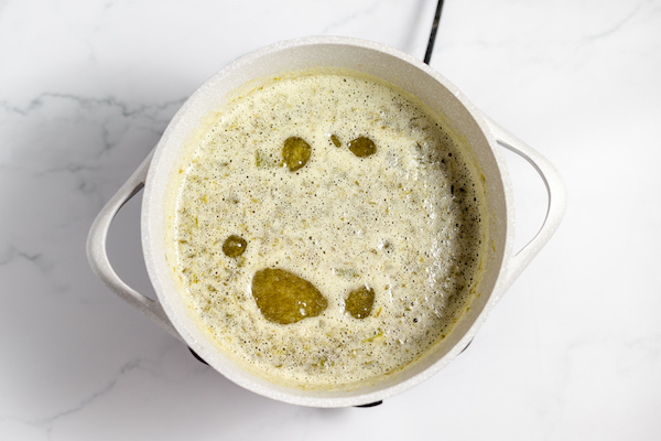 Image, taken from above, shows the boiling jalapeño jelly in a pot. 