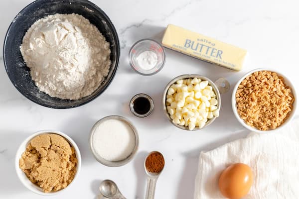 Image, taken from above shows bowls and measuring spoons full of the ingredients for making espresso toffee cookies.