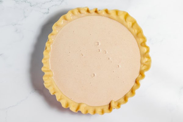 pie filling in pie shell, ready to bake