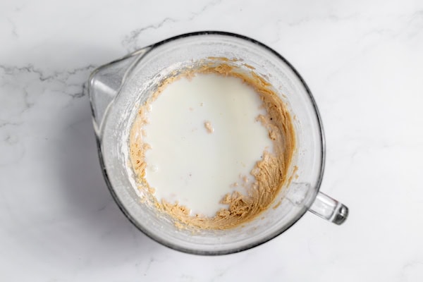 adding milk to apple bread batter
