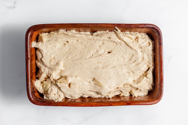 apple bread in a loaf pan, ready to bake