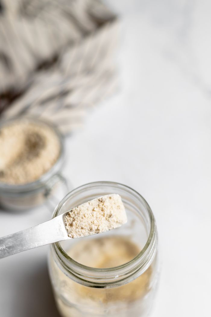 adding sourdough starter powder to a jar