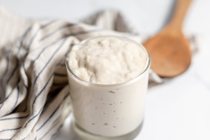 jar with wooden spoon and towel