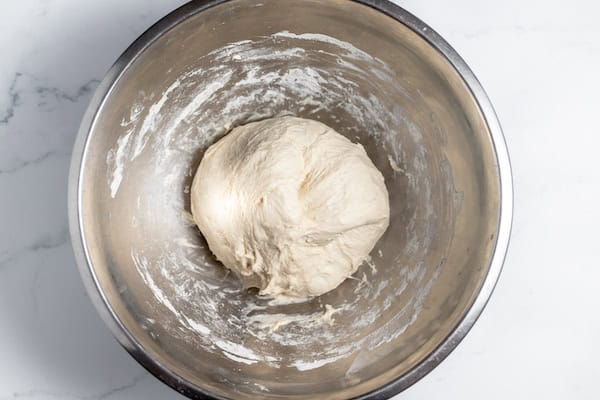 Image, taken from above, shows a ball of sourdough dough ready for stretch and fold