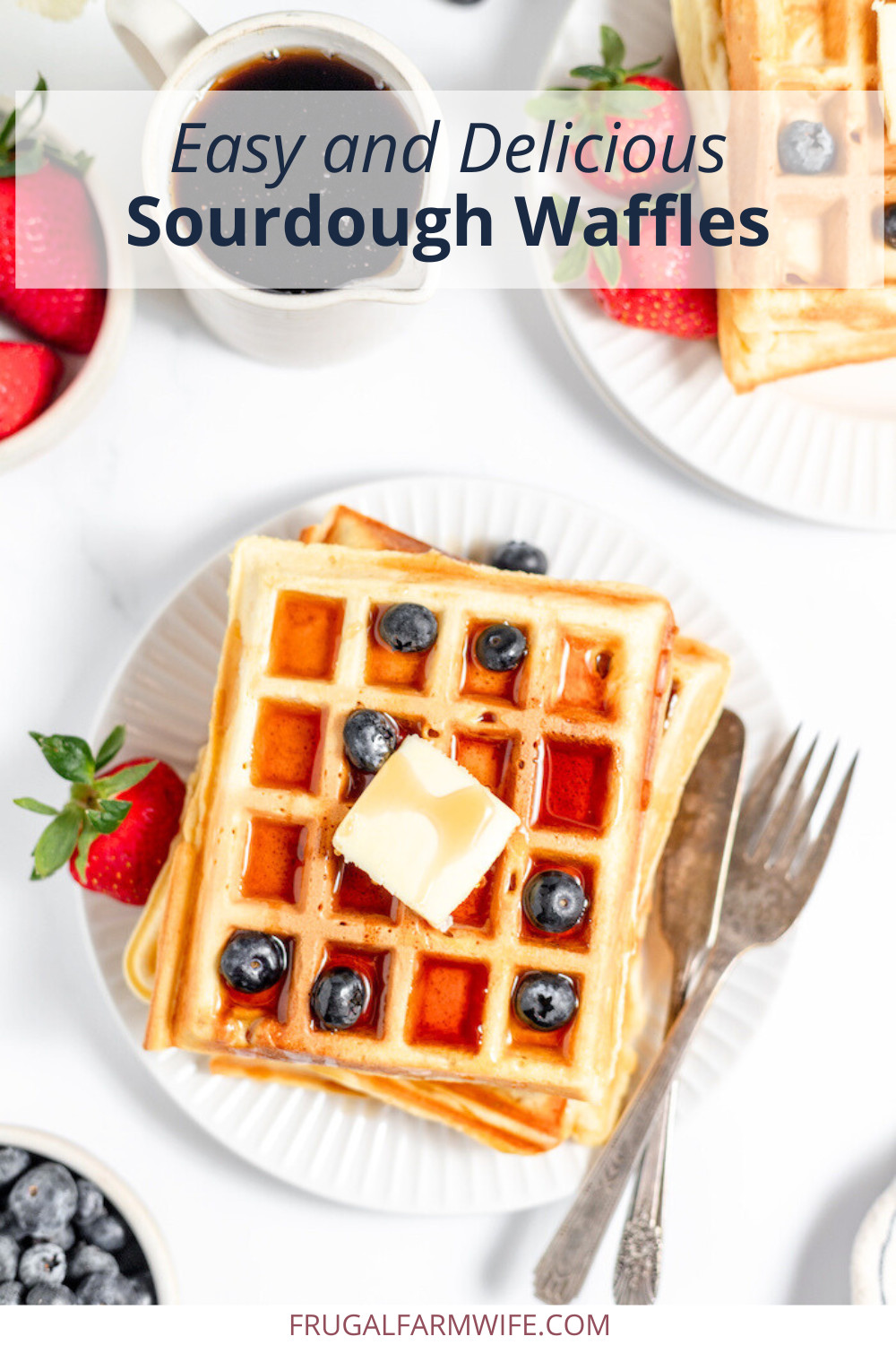 Image, taken from above shows sourdough waffles on a plate with butter, berries, and syrup. Text above reads "Easy and Delicious Sourdough Waffles"