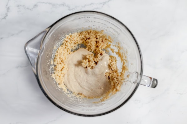 Image, taken from above shows what it looks like when you add sourdough starter in a bowl with butter and brown sugar
