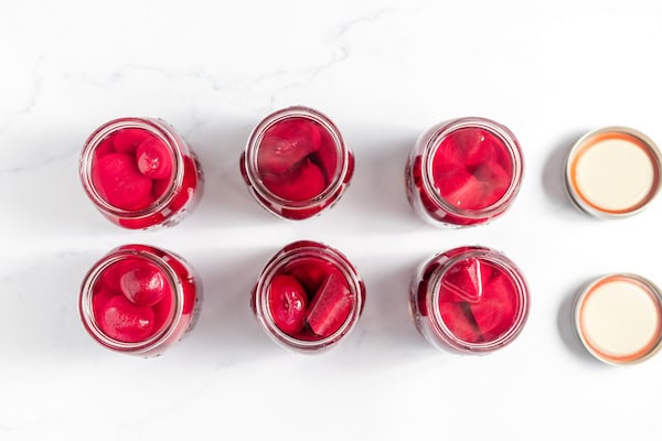jars of beets filled with salt and water, ready to can