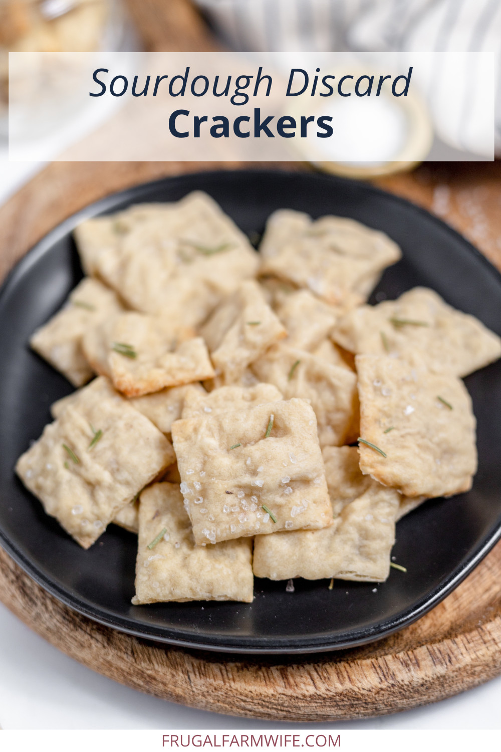 Image shows a small black plate full of homemade sourdough discard crackers. Text above reads "Sourdough Discard Cracker."