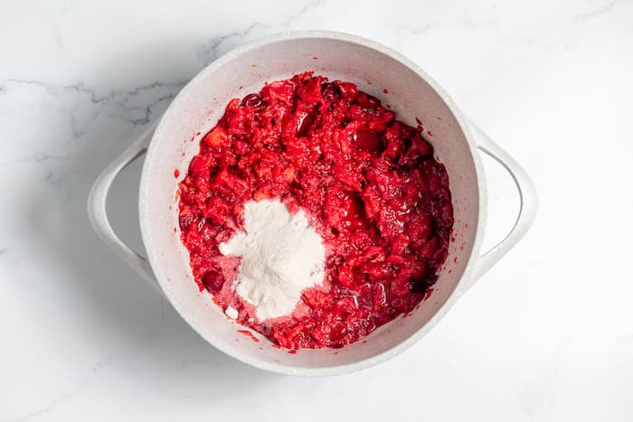 Chopped cherries in a pot with fruit pectin