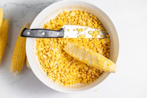 cutting corn off the cobb for canning