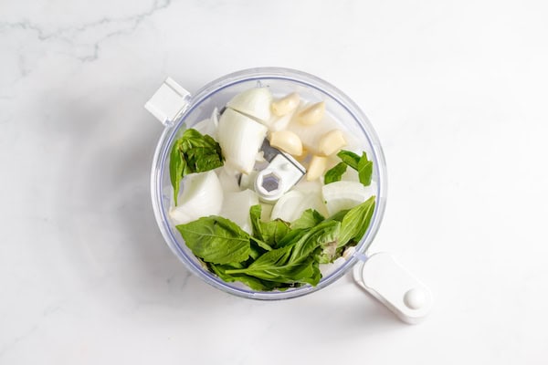 onion, garlic, and basil in a food processor