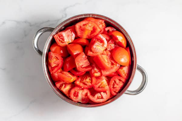 quartered tomatoes ready to cook