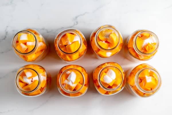 salt on top of butternut squash in jars