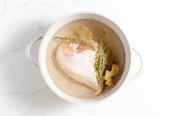 chicken in a pot with herbs