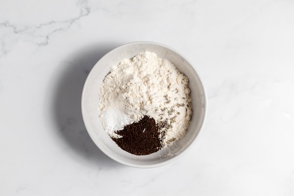 Image, taken from above, shows a bowl of flour, baking powder, earl grey tea ready to be mixed.