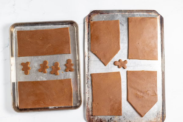 Image, taken from above, shows baking sheets with gluten free gingerbread pieces on them ready to be baked