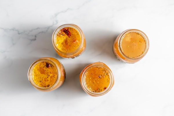 Image, taken from above shows broth added to split pea soup jars. 