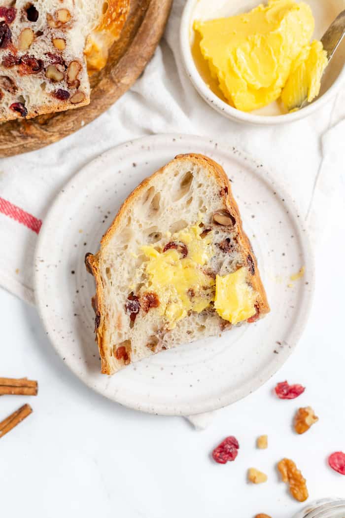 buttered slice of sourdough cranberry walnut bread
