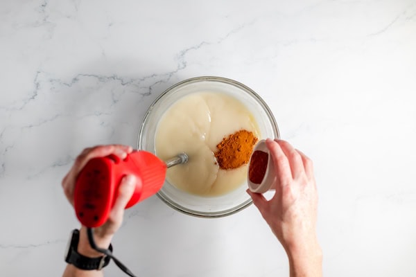adding turmeric to soap mixture