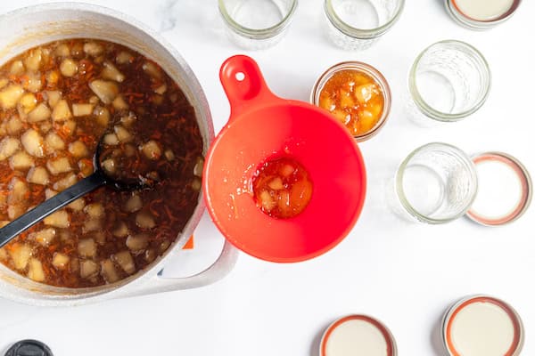 filling jars with carrot cake jam