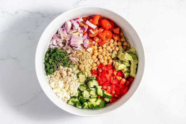 salad ingredients piled in a large bowl