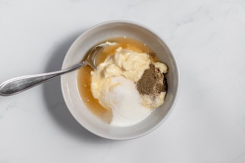 dressing ingredients in a bowl for broccoli pasta salad