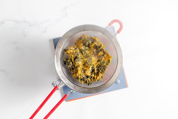 strained dandelions from making dandelion tea