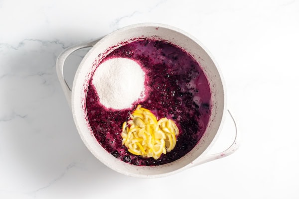 blueberries, lemon, and pectin in pot