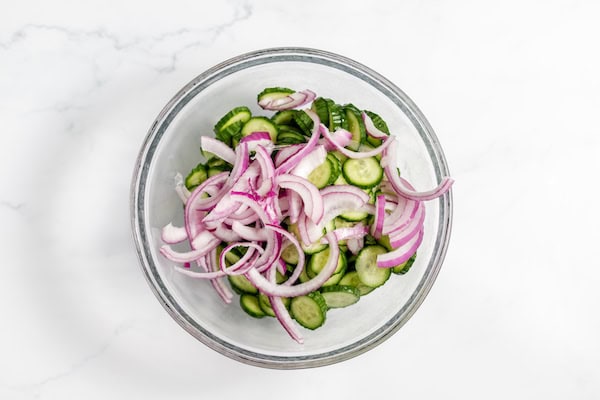 sliced cucumbers and onions in a bowl