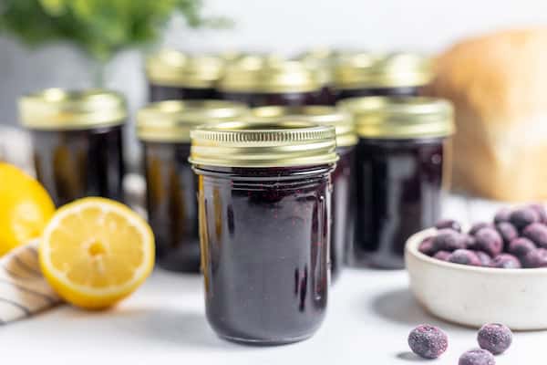 jars of jam with lemon and blueberry on a table