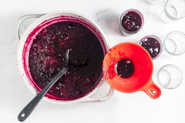 ladling hot jam into jars for canning