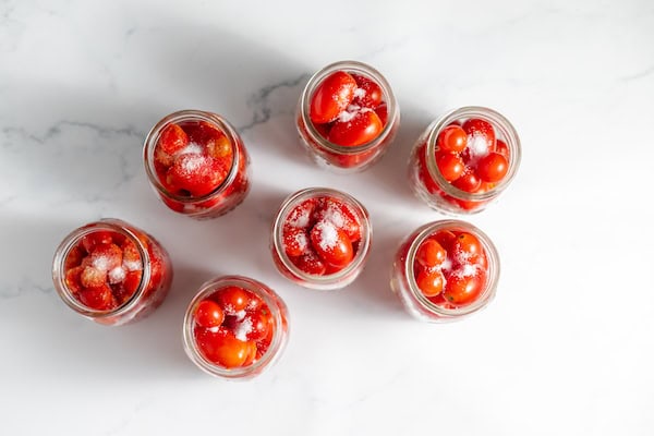 cherry tomatoes in jars with salt and lemon juice