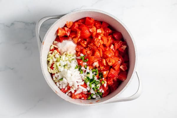 peppers, onions, and celery with tomatoes in a pot