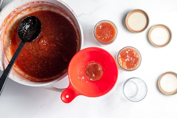ladling fig jam into jars