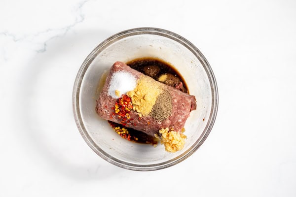ground bison and seasonings in a bowl