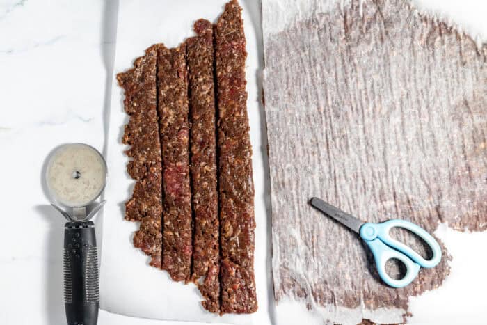 scoring elk jerky with a pizza cutter