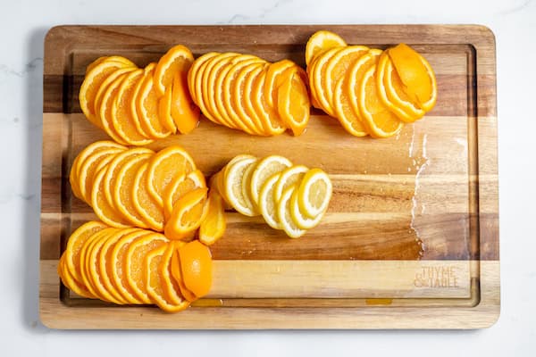 cutting board full or sliced oranges and lemon